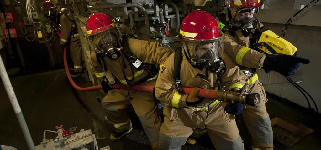 120114-N-DR144-704  ARABIAN SEA (Jan. 14, 2012) Hull Maintenance Technician 3rd Class Oscar Williams, left, Hull Maintenance Technician Fireman Matthew Colon, and Damage Controlman Fireman Donovan Jopling, lead a hose team as they combat a simulated fire in an aircraft elevator machinery room during a general quarters drill aboard the Nimitz-class aircraft carrier USS Carl Vinson (CVN 70). Carl Vinson and Carrier Air Wing (CVW) 17 are deployed to the U.S. 5th Fleet area of responsibility. (U.S. Navy photo by Mass Communication Specialist 2nd Class James R. Evans/Released)